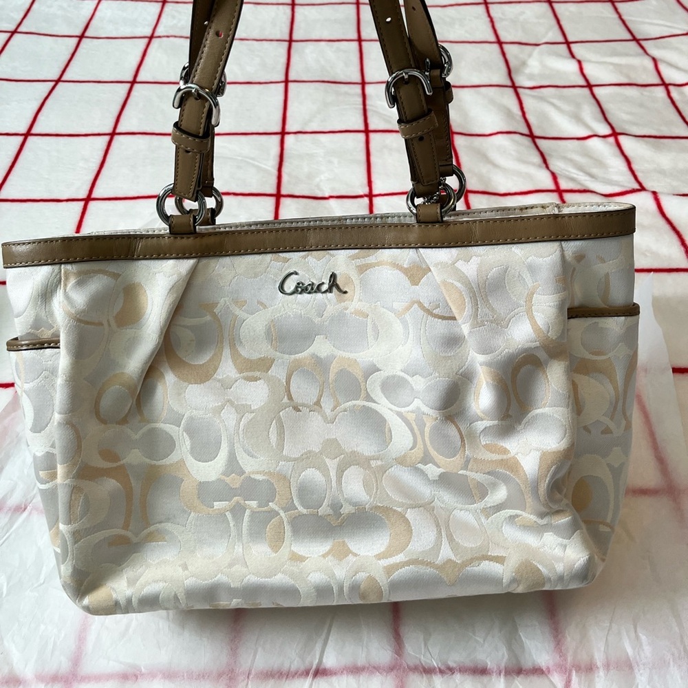 Coach cream and tote or shoulder. Light marks on it.